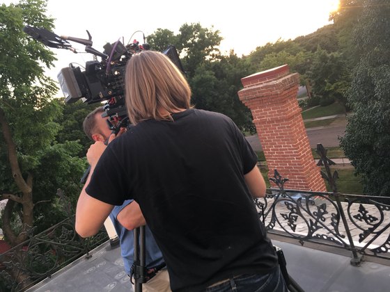 Camera operator filming from a balcony