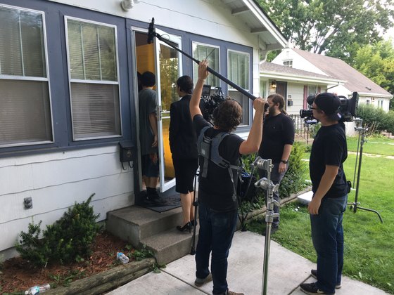 Crew preparing a scene outside a house