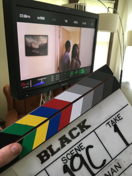 Black slate in front of a camera monitor