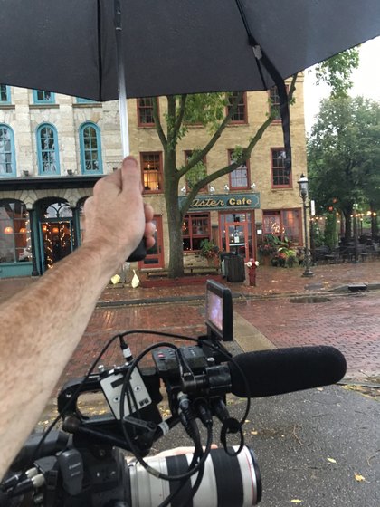 Boom microphone and camera equipment on a sidewalk