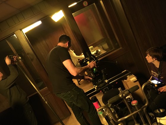 Crew working with a camera in a small room