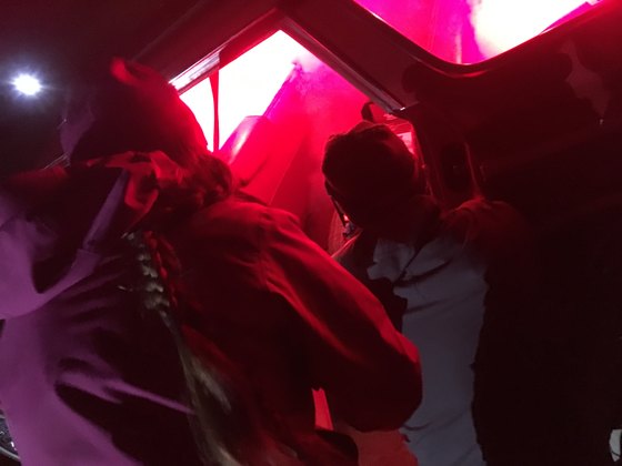 Crew under red light inside a vehicle